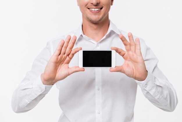 Gros plan le portrait d'un homme souriant dans une chemise blanche