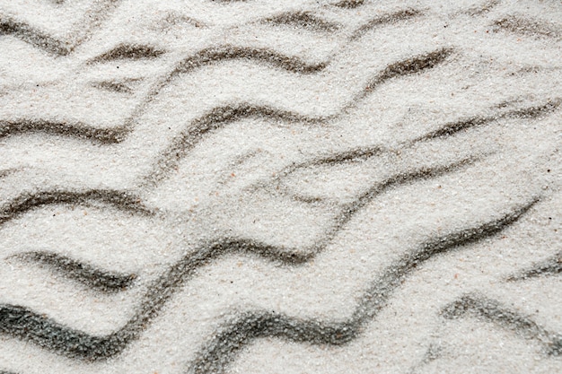 Photo gratuite gros plan de sable avec des lignes ondulées