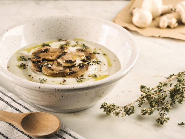 Photo gratuite gros plan sur une soupe blanche, crémeuse et rustique avec des champignons sur la table