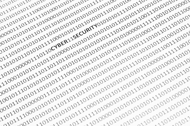 Gros plan d'une surface blanche avec la cybersécurité et le code binaire