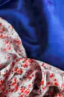 Photo gratuite gros plan de tissu design floral sur textile bleu lisse