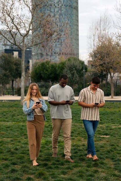 Groupe d'amis lisant des messages de téléphone portable