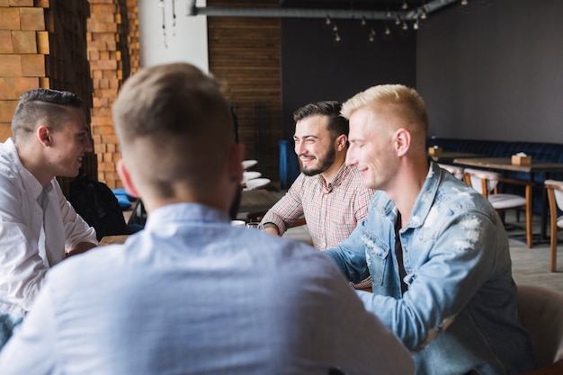 Groupe d&#39;amis masculins assis dans le restaurant