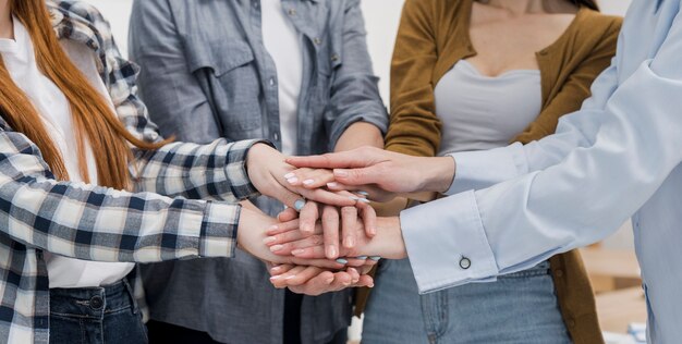 Groupe d'amis de sexe féminin touchant les mains