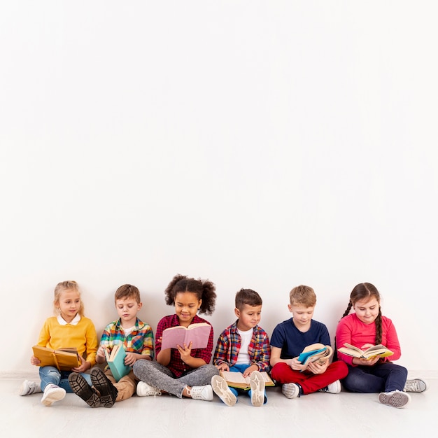 Groupe de copie-espace d'enfants sur la lecture au sol