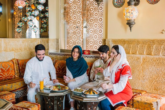 Groupe de quatre amis musulmans au restaurant