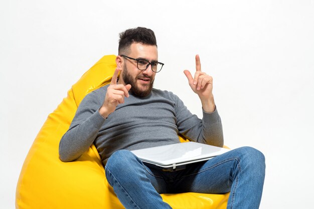 Guy a pris une idée alors qu'il était assis sur une chaise pouf jaune