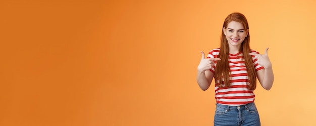 Photo gratuite habile belle fille rousse motivée pointant elle-même indiquer la poitrine des doigts se vantant joyeusement