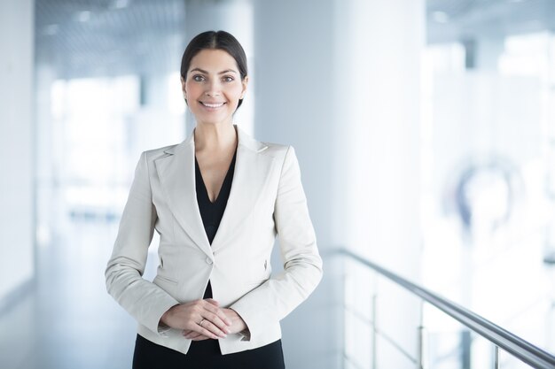 Happy Elegant Business Woman in Office Hall