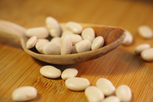 Haricots dans une cuillère en bois