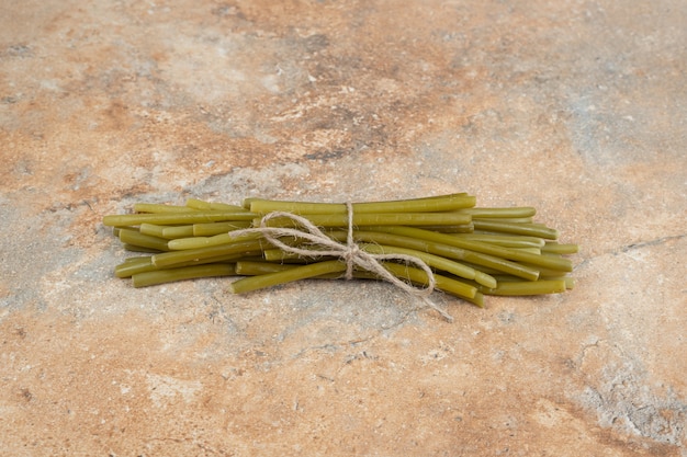 Photo gratuite haricots verts marinés sur une surface en marbre