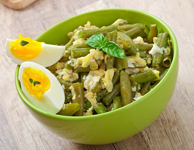 Haricots verts avec des œufs dans un bol.