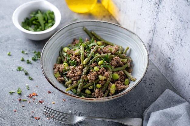 Haricots verts avec de la viande hachée dans un bol