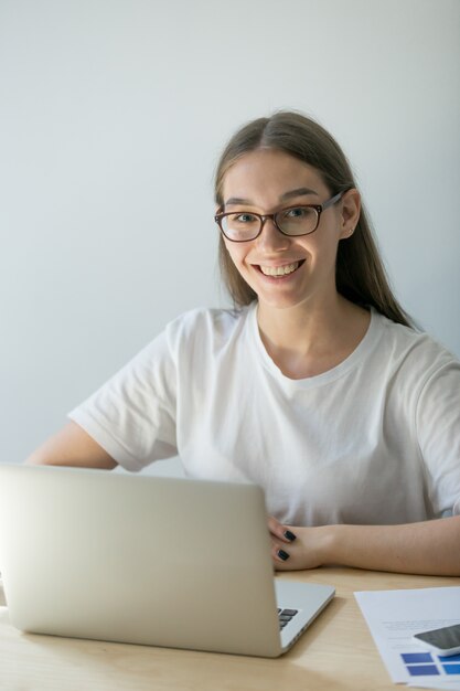 Heureuse femme posant au bureau