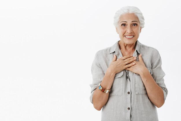 Heureuse grand-mère heureuse à la recherche de plaisir, souriant heureux et surpris