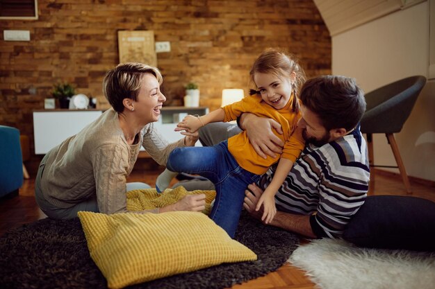 Heureuse petite fille s'amusant avec ses parents à la maison