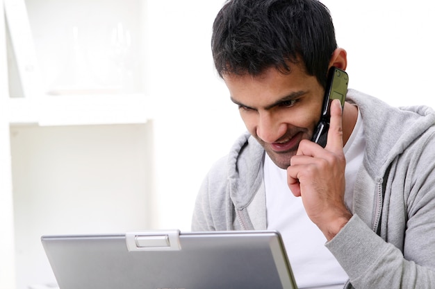 Heureux homme jeune et attrayant avec téléphone