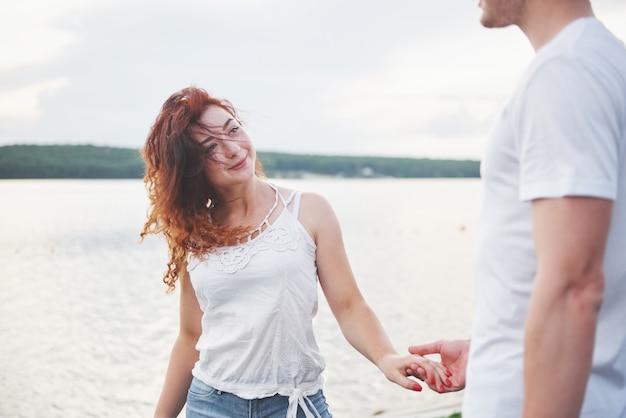 Photo gratuite heureux jeune couple bénéficiant d'une plage solitaire