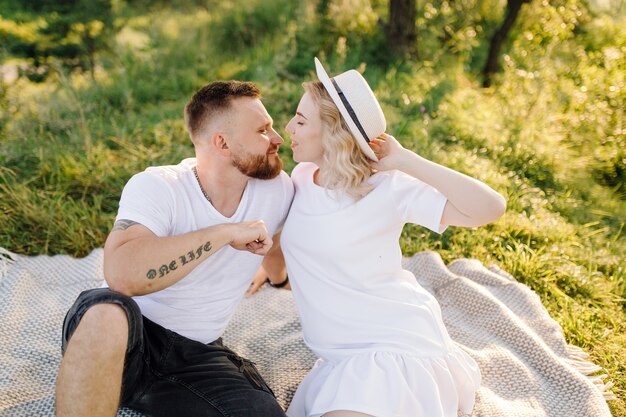 Heureux portrait de couple d'amoureux lors d'une promenade dans le parc par une journée ensoleillée.