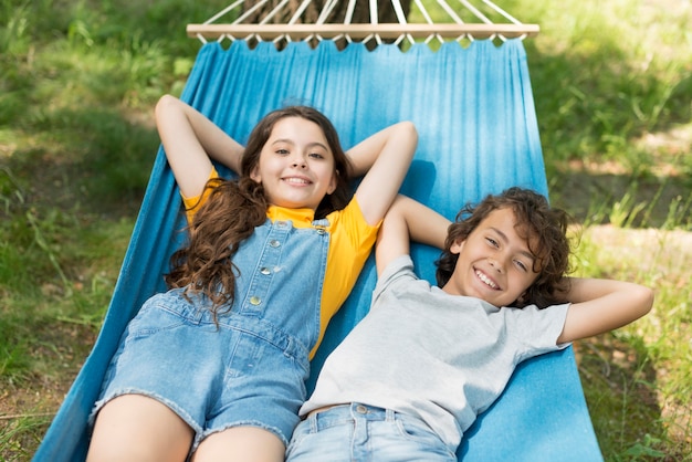 High angle childrens sitting in hamac