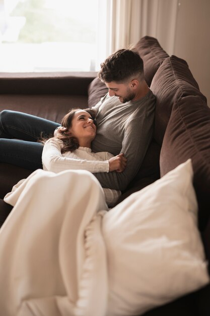 High angle jeune couple se détendre sur un canapé