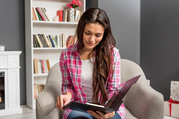 High angle woman looking on clipboard