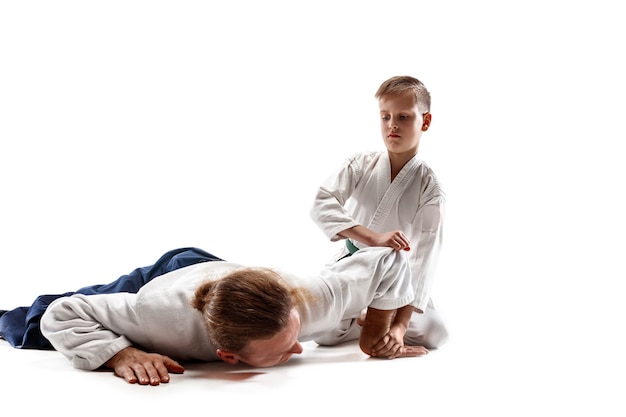 Photo gratuite l'homme et l'adolescent se battre à la formation d'aïkido à l'école d'arts martiaux