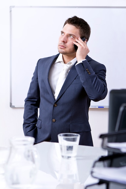 Homme d'affaires prospère à l'aide de téléphone portable