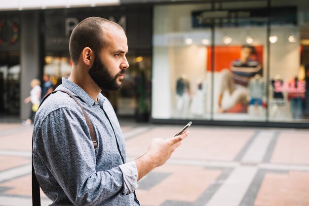 Homme d&#39;affaires réfléchie en utilisant le téléphone à la rue