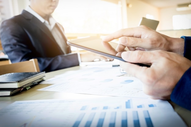 Homme d&#39;affaires travaillant avec tablette numérique et téléphone intelligent et ordinateur portable.