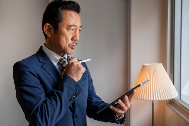 Photo gratuite homme d'affaires travaillant sur la vue de côté d'ipad