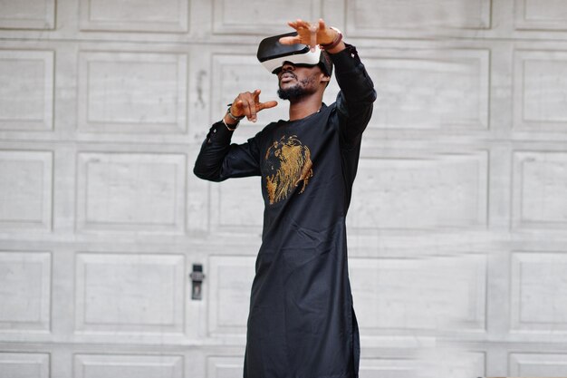 Homme africain riche en vêtements traditionnels élégants dans des lunettes vr Concept de l'avenir de l'Afrique