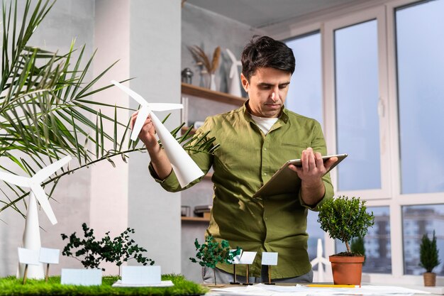 Homme à l'aide de tablette pour une mise en page de projet d'énergie éolienne écologique