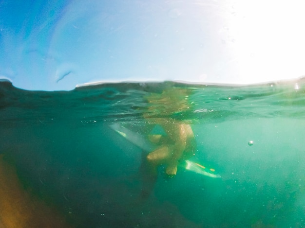 Photo gratuite homme assis sur une planche de surf en mer