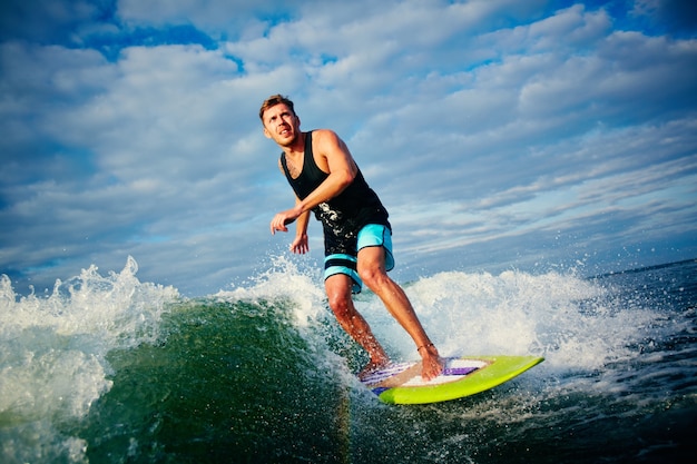 L&#39;homme ayant du plaisir avec la planche de surf