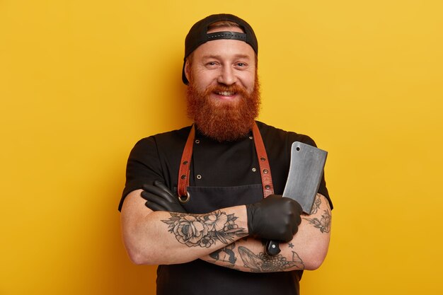 Homme avec barbe de gingembre en tablier et gants