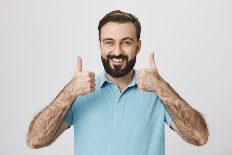 Photo gratuit homme barbu souriant satisfait montrant le pouce en l'air d'approbation