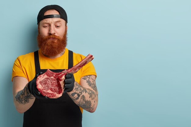 Homme Boucher Avec Barbe Au Gingembre Tenant De La Viande