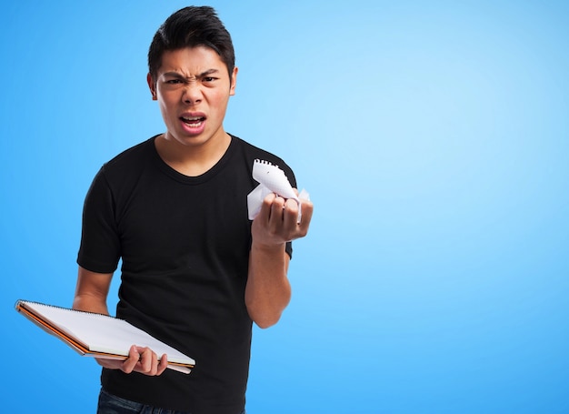 Homme en colère plissant une feuille