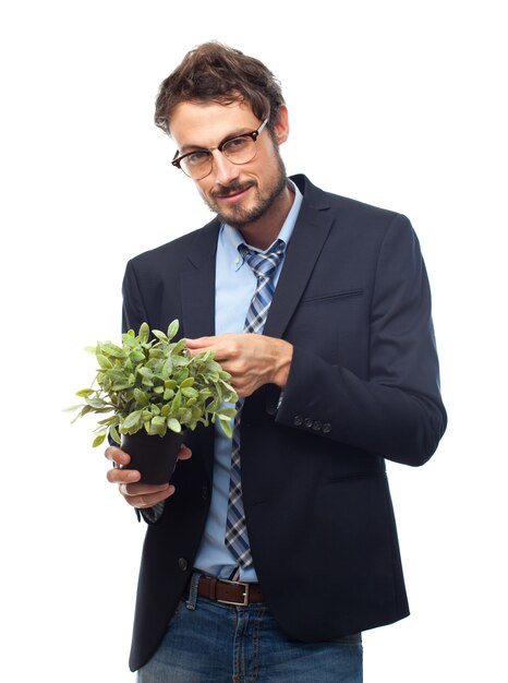 L&#39;homme avec le costume et des lunettes pour regarder avec une plante