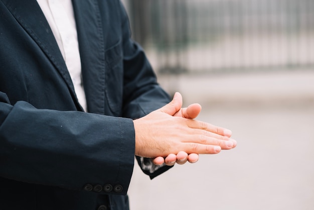 Photo gratuite homme en costume se frottant les mains