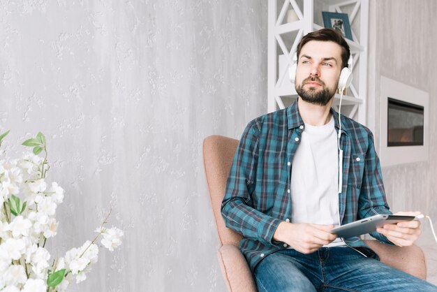 Homme écoutant de la musique et regardant ailleurs