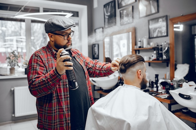 Photo gratuite homme élégant assis dans un salon de coiffure