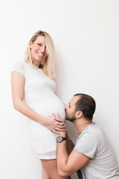 Homme embrassant le ventre de femme enceinte