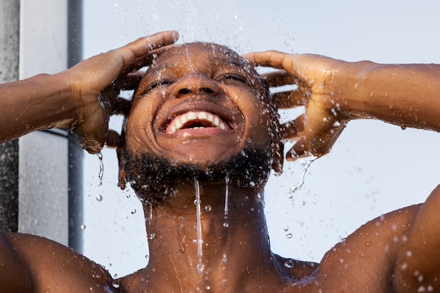 Photo gratuite homme à faible angle prenant un portrait de douche