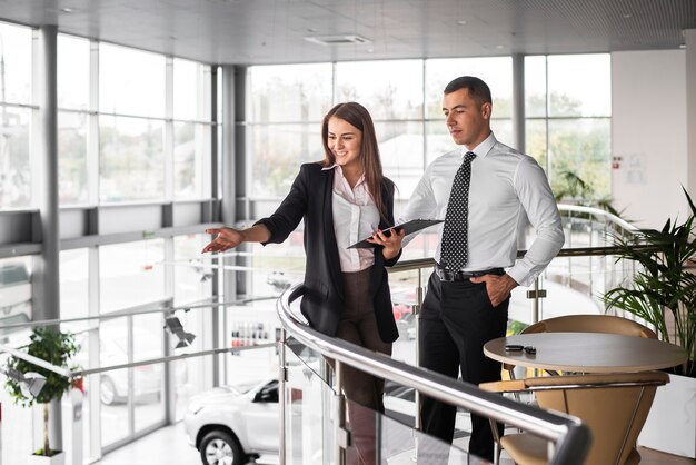 Homme et femme chez un concessionnaire automobile ensemble