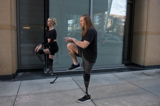 Homme et femme avec un handicap aux jambes faisant de l'exercice dans la ville