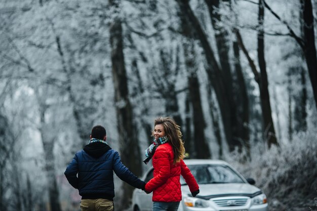 Homme et femme marchant ensemble sur le parc d'hiver