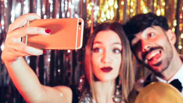 Homme et femme prenant selfie sur la fête du nouvel an