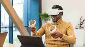 Photo gratuite un homme noir excité explorant la réalité virtuelle dans un bureau